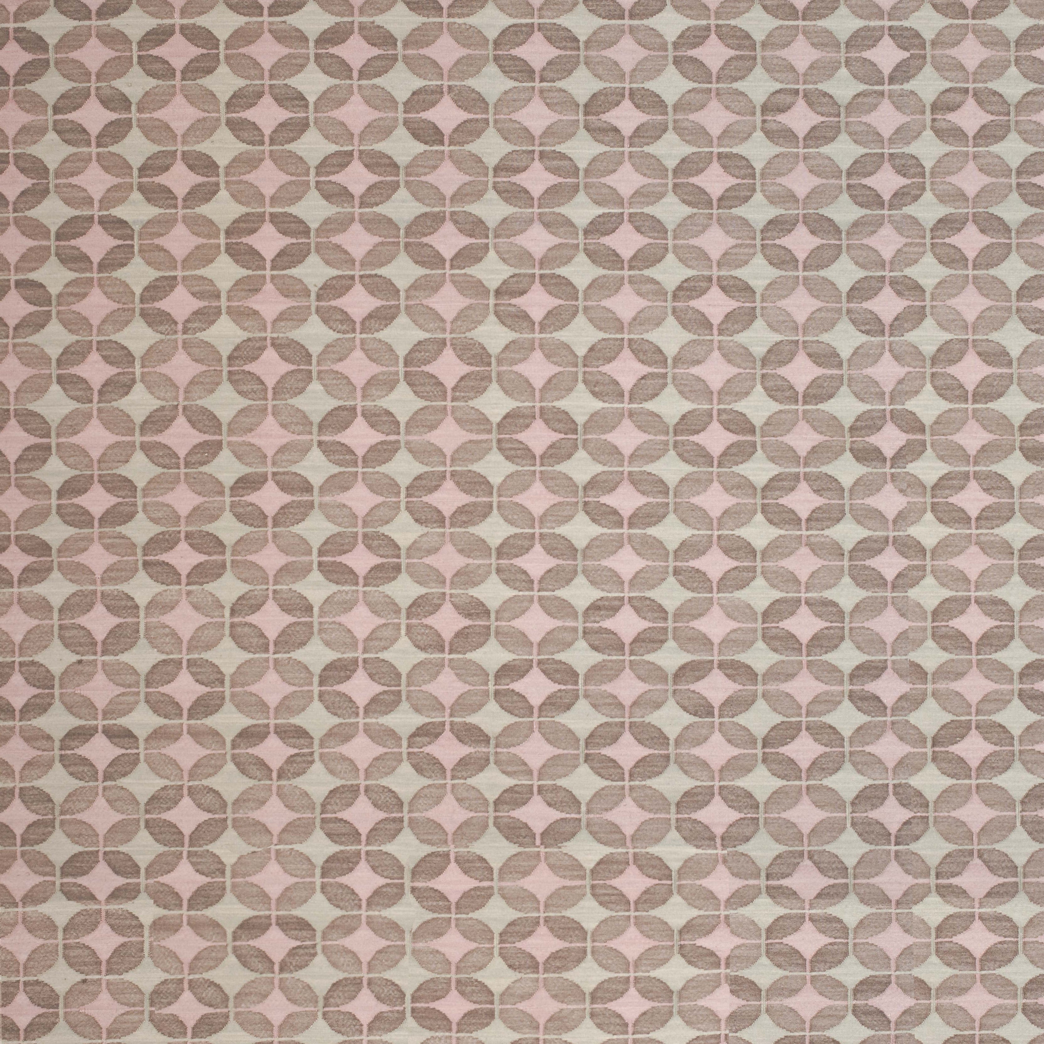 Petite Alhambra Rug featuring a pattern of linked circles that create a star like lattice in ivory and pink on a taupe field. 