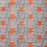 Fabric swatch with a stamped painted floral motif in red and cobalt on a medium blue background