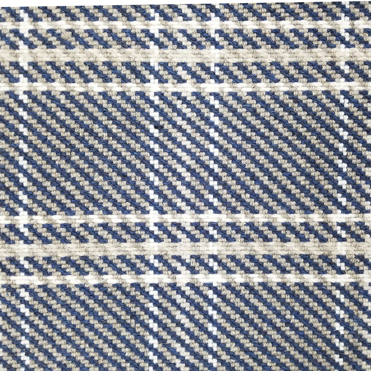 Wool broadloom carpet swatch in houndstooth plaid in shades of navy, cream and white.
