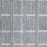 Wool broadloom carpet swatch in a plaid print in shades of navy, tan and cream.