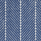 Wool broadloom carpet swatch in a woven chevron pattern in navy and white with white accent stripes.