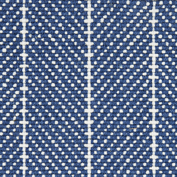 Wool broadloom carpet swatch in a woven chevron pattern in navy and white with white accent stripes.