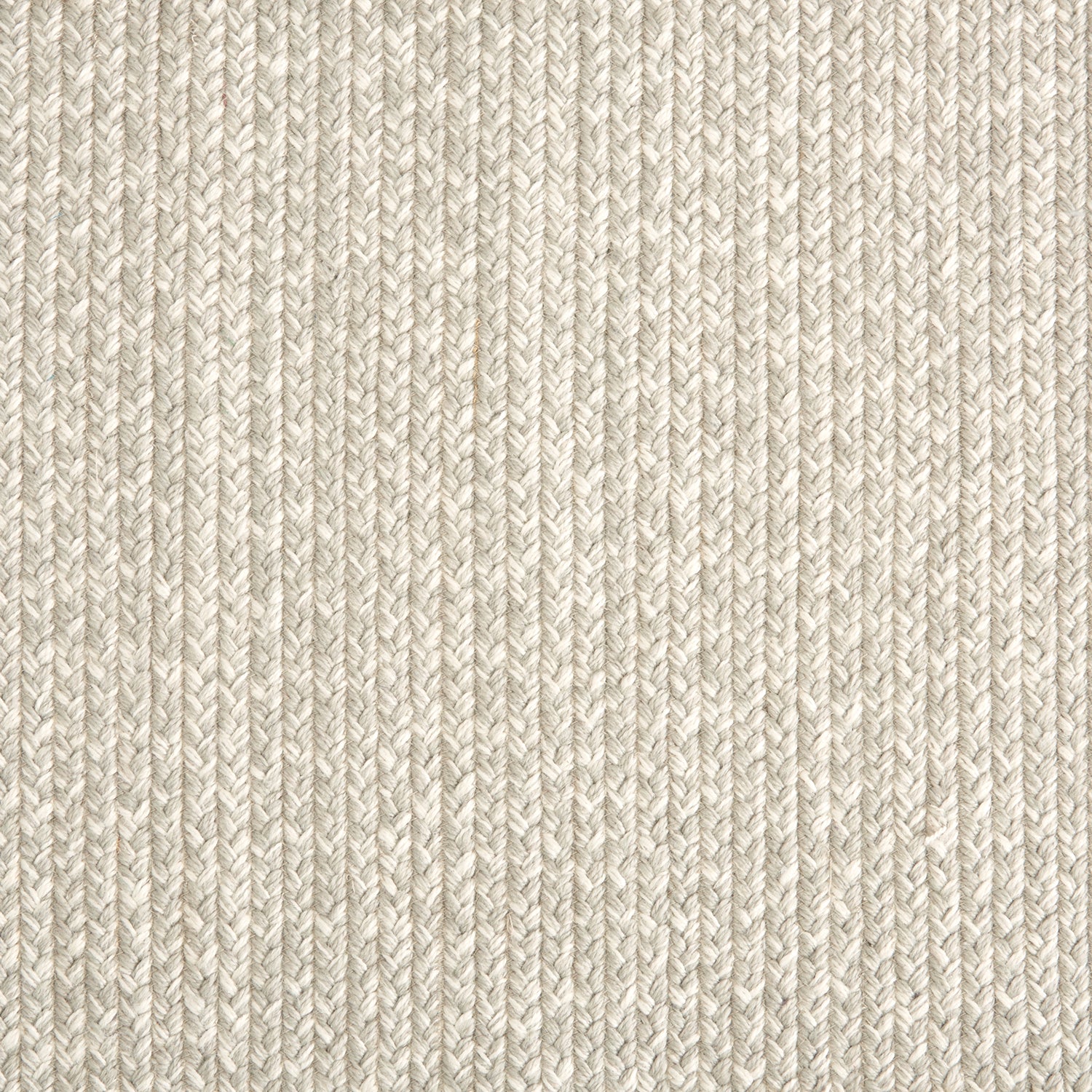 Outdoor broadloom carpet swatch in a chunky ribbed weave in mottled cream and silver.