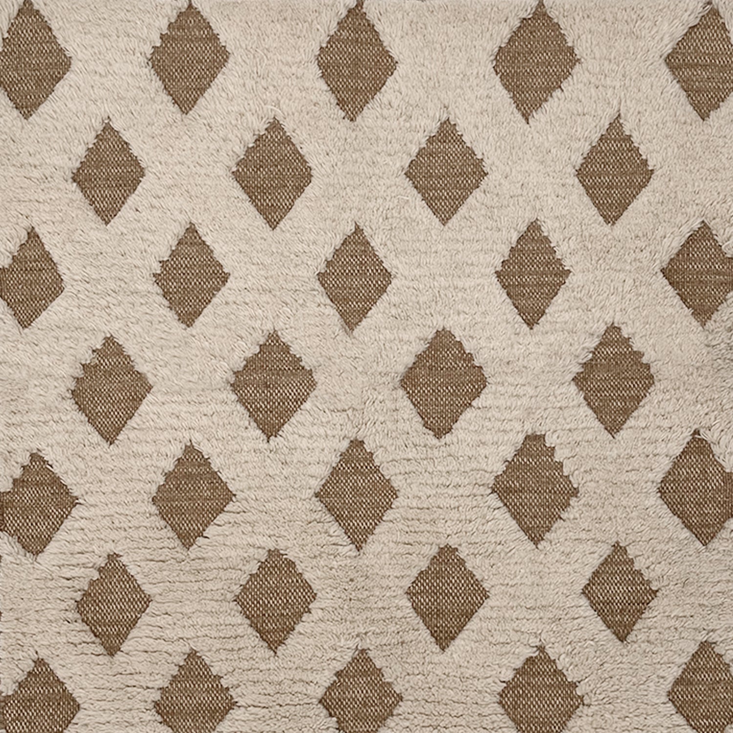 Rug swatch with a repeating tan diamond pattern on a high-pile white field.