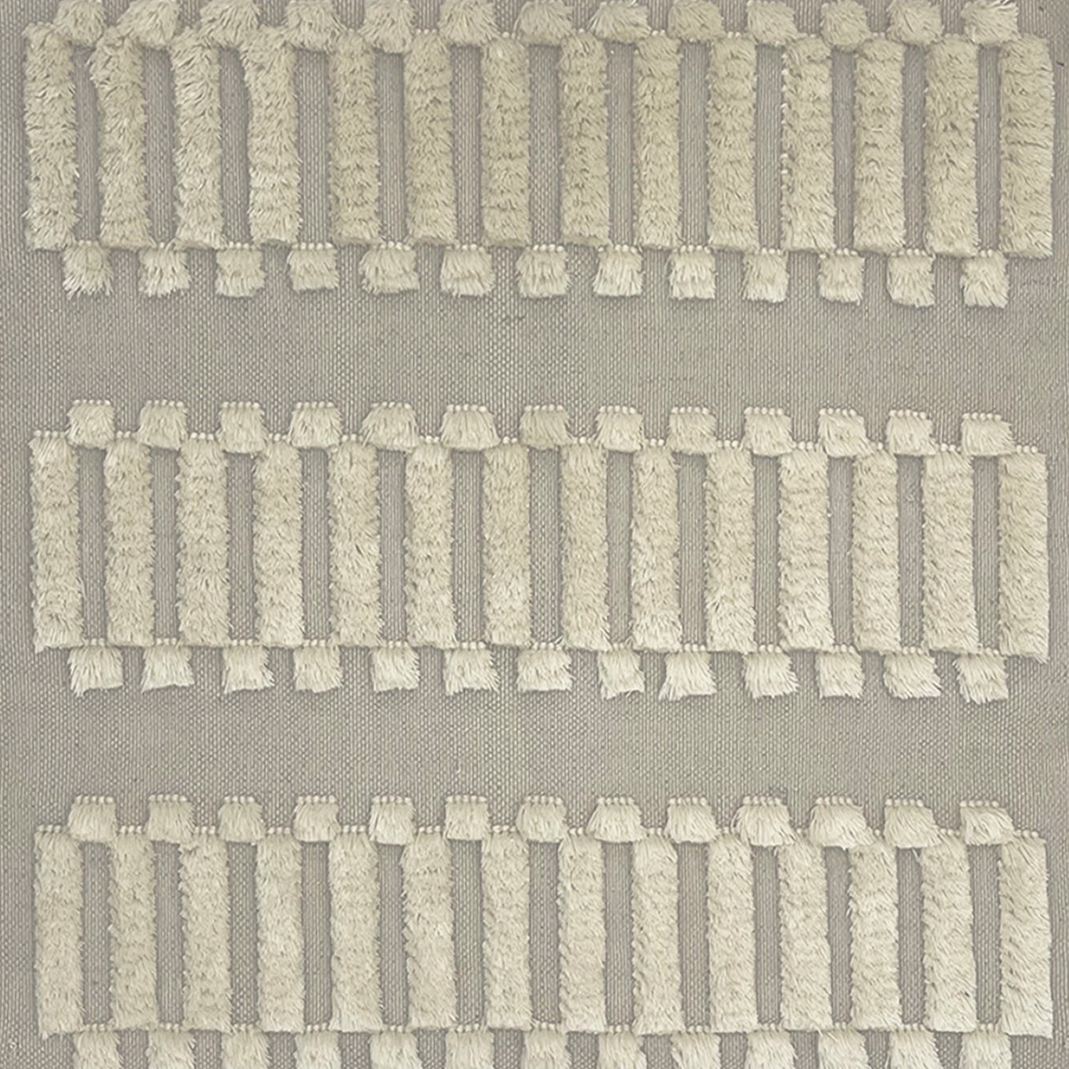 Woven rug swatch with a repeating pattern of high-pile fringed stripes in cream on a gray field.
