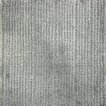 Nylon broadloom carpet swatch in a ribbed weave in grey.