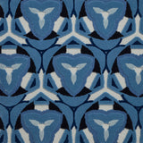 Detail of Gigi Rug featuring a geometric floral motif with a mix of cut pile and linear loops in ivory and shades of blue