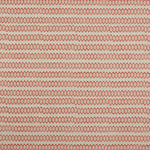 Swatch of fabric with rows of hand-drawn red and peach honeycomb shapes on a tan background.