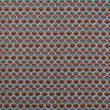 Swatch of fabric with a repeating Japanese-inspired scalloped pattern in shades of navy, blue and red. 