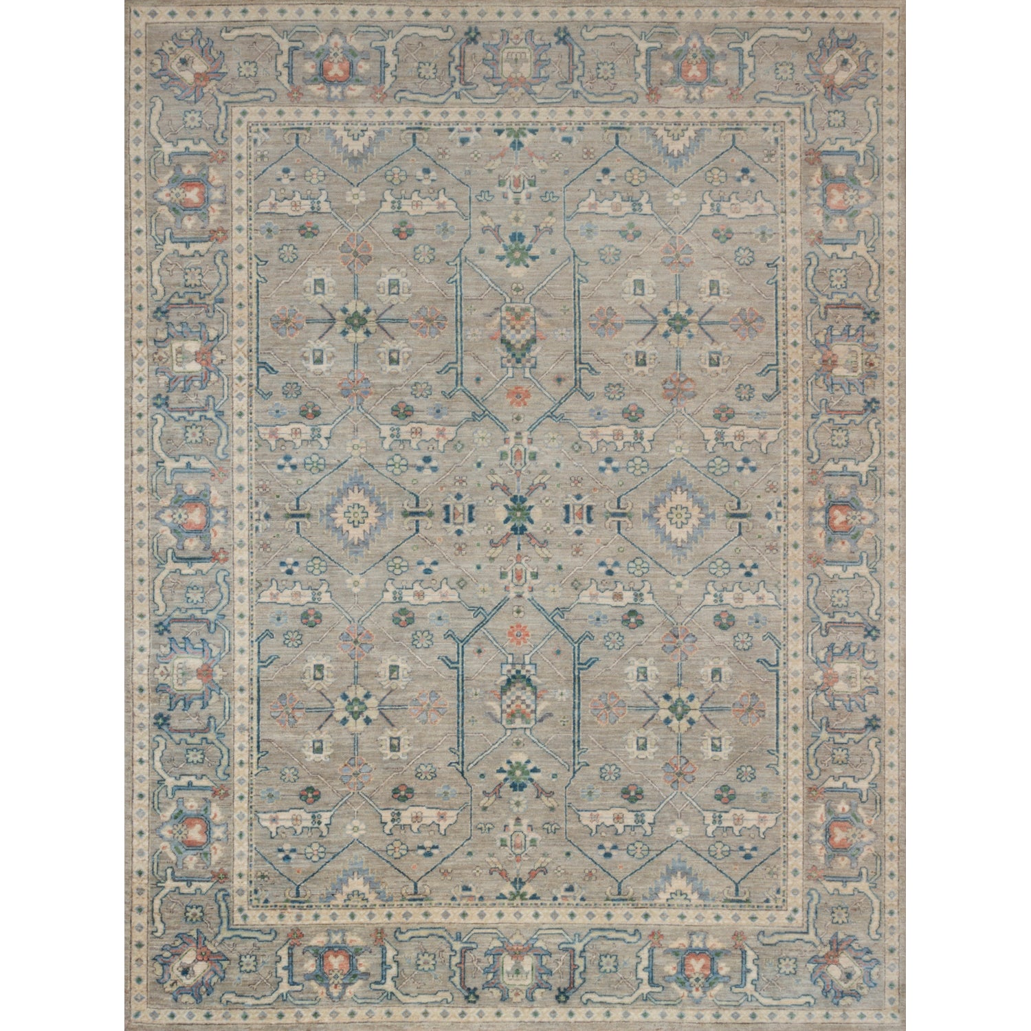 Large rectangular rug in a repeating geometric print with a floral border in shades of blue-gray, rust and navy.