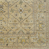 Rug swatch in a repeating geometric print with a floral border in shades of cream, gold and brown.