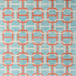 Woven rug swatch in an interlocking geometric buckle pattern in coral and white on a light blue field.