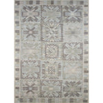 Large rectangular rug in a repeating abstract geometric pattern with a border of jagged geometric shapes, all in shades of gray.