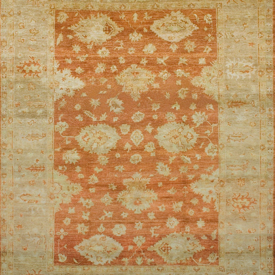 Large rectangular rug with a minimalist floral pattern in tan on a red field, with a tan border of linear florals in red.