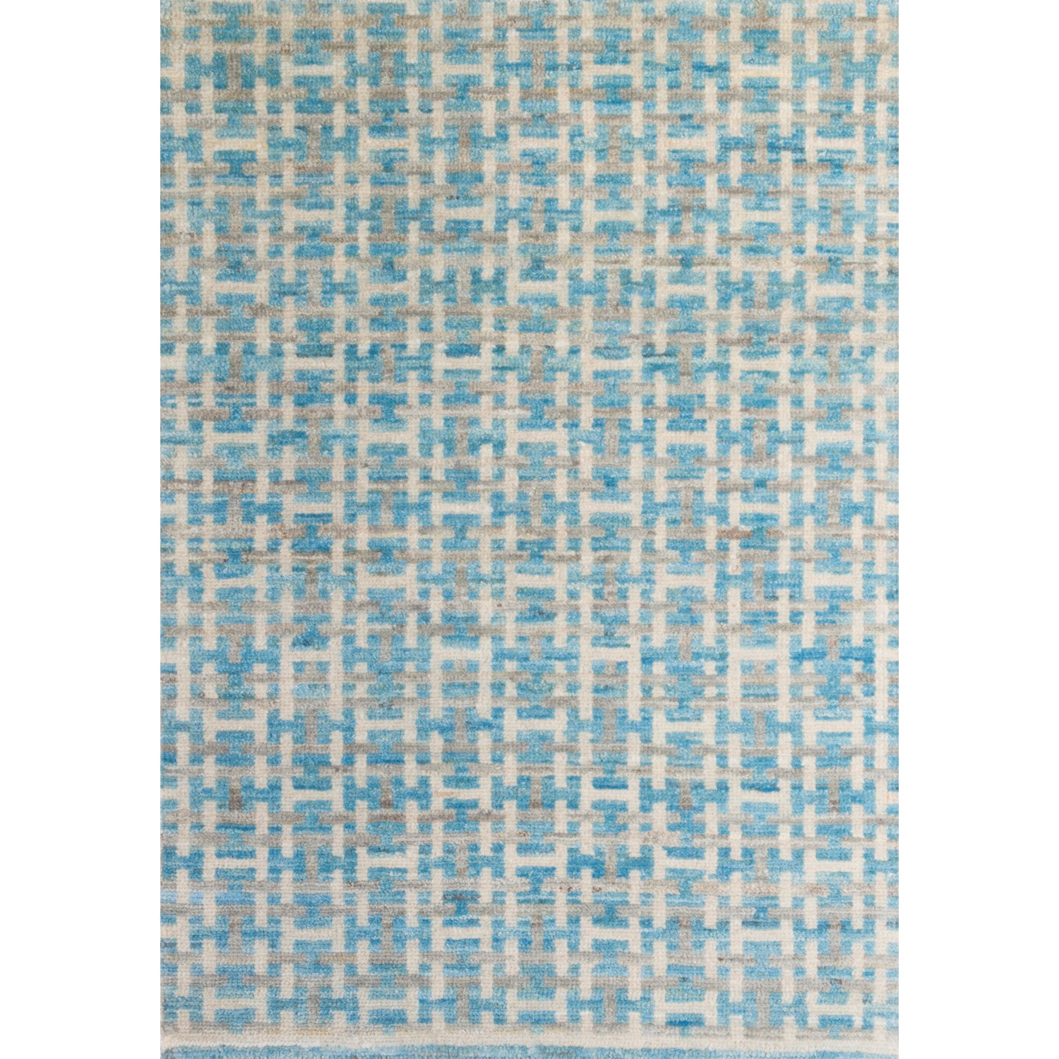 Large rectangular rug with an interlocking linear "gate" pattern in shades of white and gray on a sky-blue field.
