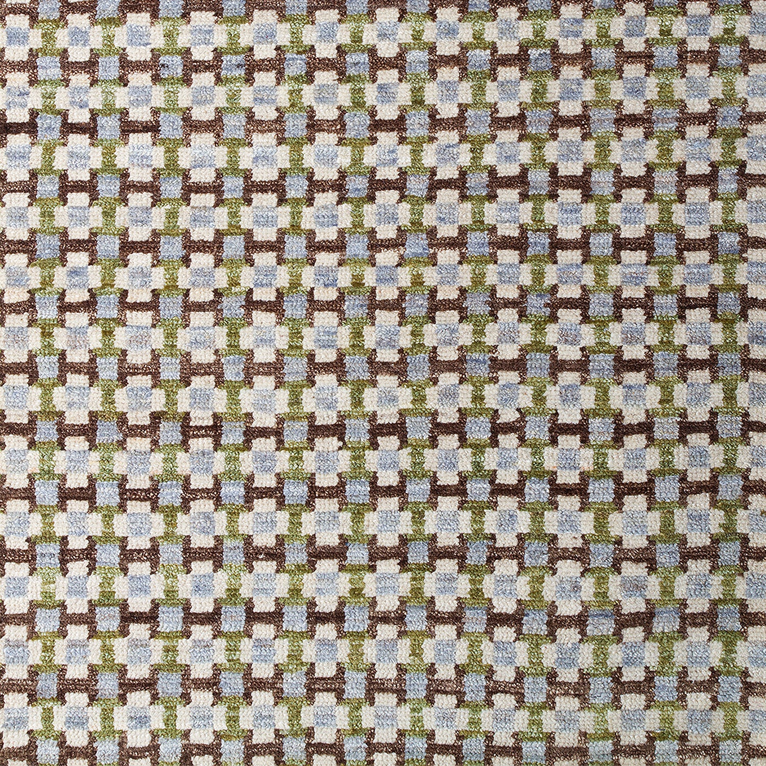 Woven rug swatch in a small-scale grid pattern featuring squares of cream, blue, green and brown.
