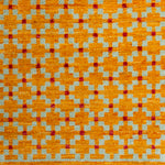 Woven rug swatch in a large-scale grid pattern featuring squares of mustard, light blue and red.