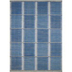 Rectangular rug in a stripe motif broken by rows of rectangular shapes in white on a blue and green field.