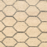 Woven rug swatch in a linear honeycomb pattern in black on a tan field.
