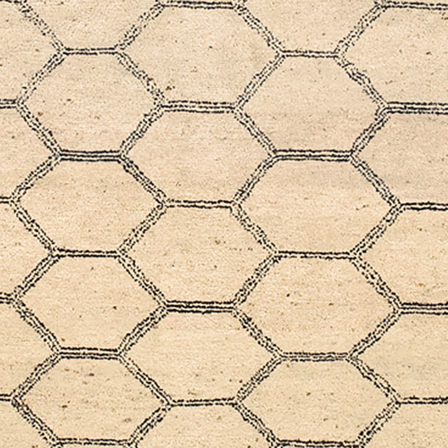 Woven rug swatch in a linear honeycomb pattern in black on a tan field.
