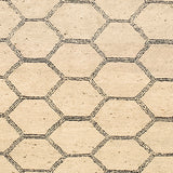 Woven rug swatch in a linear honeycomb pattern in black on a tan field.