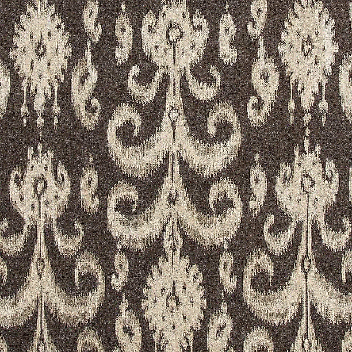 Detail of a woven rug with a cream ikat fleur de lis pattern on a black field.