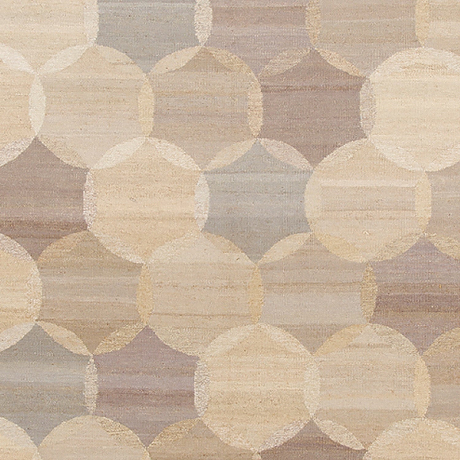 Woven rug swatch in an interlocking circles pattern in shades of cream, tan and gray.