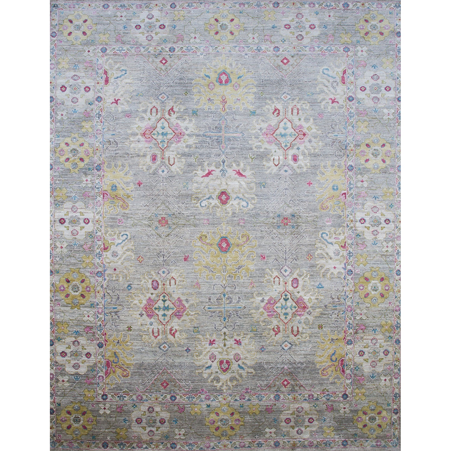 Large rectangular rug in an abstract floral pattern with a repeating floral border print in shades of pink, yellow and red on a mottled gray field.