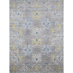 Large rectangular rug in an abstract floral pattern with a repeating floral border print in shades of yellow, blue and gray on a mottled gray field.