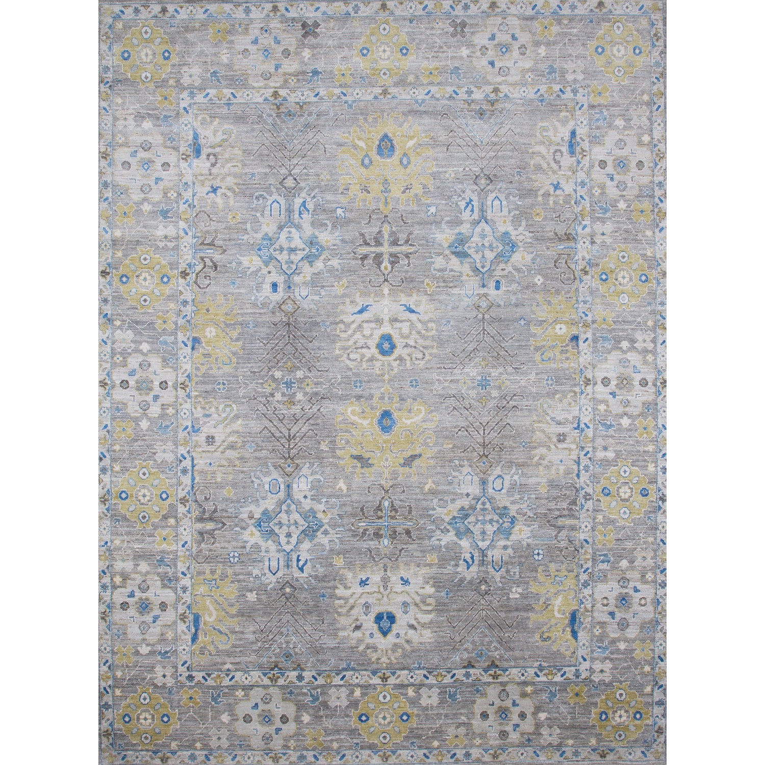 Large rectangular rug in an abstract floral pattern with a repeating floral border print in shades of yellow, blue and gray on a mottled gray field.