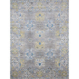 Large rectangular rug in an abstract floral pattern with a repeating floral border print in shades of yellow, blue and gray on a mottled gray field.
