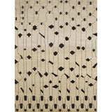 Rectangular high-pile woven rug in an abstract "lantern" line pattern in black on a tan field.