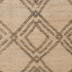 Woven high-pile rug swatch in a large-scale interlocking diamond pattern in black on a cream field.