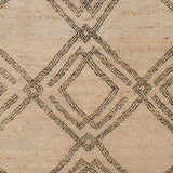 Woven high-pile rug swatch in a large-scale interlocking diamond pattern in black on a cream field.