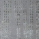 Woven high-pile rug swatch in gray with a repeating "raindrop" pattern in various shades of gray.