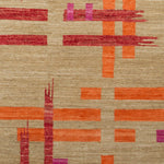Woven rug swatch with an abstract pattern of bright-colored ribbons in shades of pink and orange on a tan field.