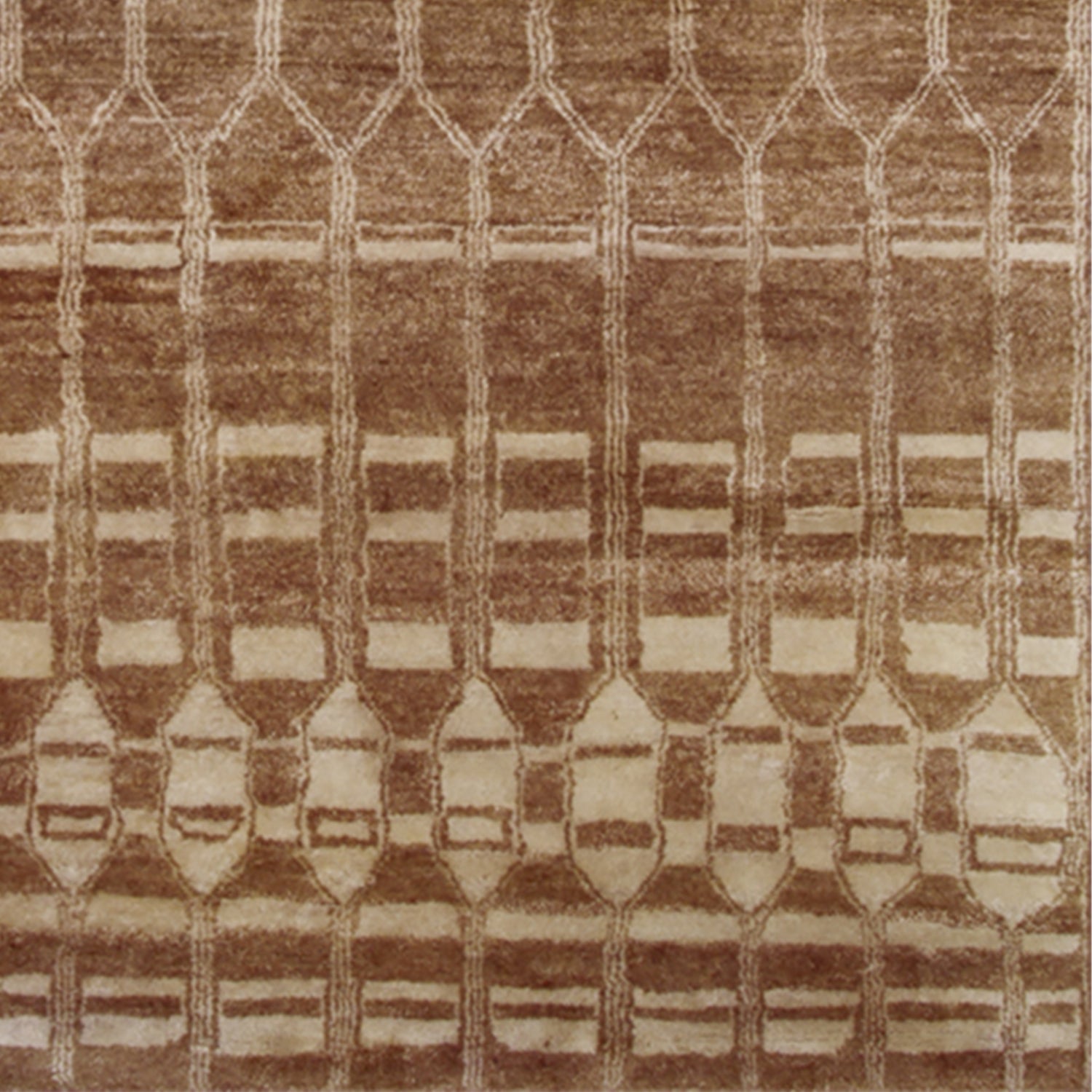 Woven high-pile rug swatch in an elongated linear honeycomb print in tan on a cream field.