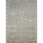 Large rectangular rug in a repeating abstract geometric pattern with a border of jagged geometric shapes, all in shades of gray.