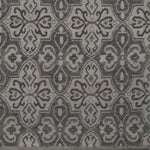 Woven rug swatch in a repeating floral paisley in shades of gray.