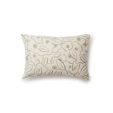 A rectangular throw pillow in a large-scale minimal floral print in shades of tan and brown on a cream background.