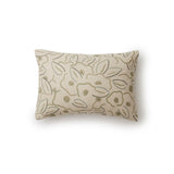A rectangular throw pillow in a large-scale minimal floral print in shades of tan and green on a cream background.