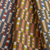 Stack of three folded swatches in a tiled stripe pattern in Carnelian, Jonquil and Cobalt