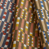 Stack of three folded swatches in a tiled stripe pattern in Carnelian, Jonquil and Cobalt