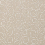 Woven fabric swatch with a large-scale repeating leaf print in white on a cream background.