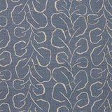 Woven fabric swatch with a large-scale repeating leaf print in tan on a French blue background.