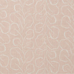 Woven fabric swatch with a large-scale repeating leaf print in white on a light pink background.